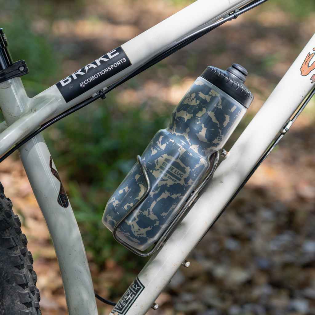 Blue Lug TR Camo 23oz insulated cycling water bottle featuring an original knobby tire tread camouflage print and Specialized Purist construction.