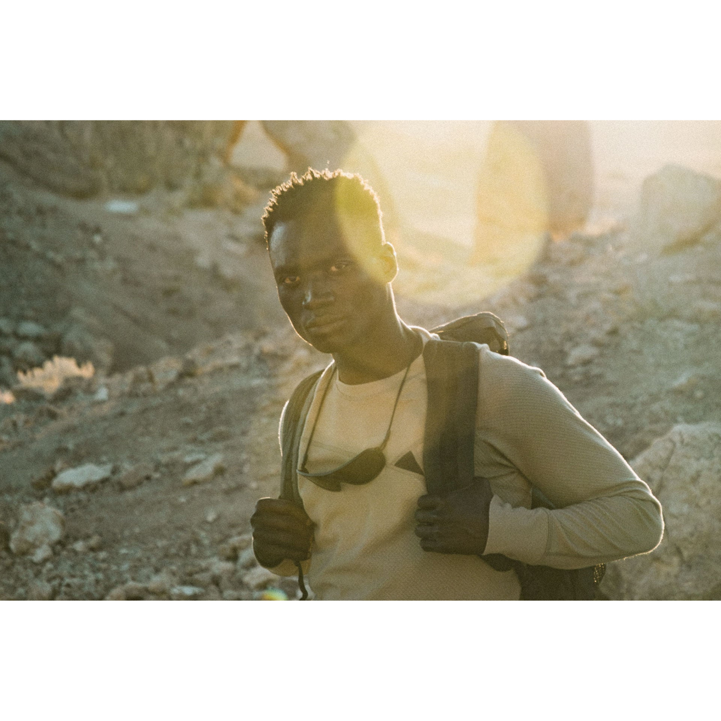 Person wearing Ombraz Refugio armless sunglasses hanging around their neck