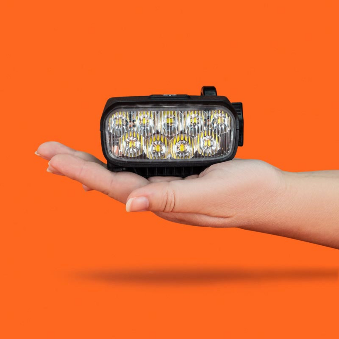 Outbound Lighting Trail Evo handlebar light being held in a hand.
