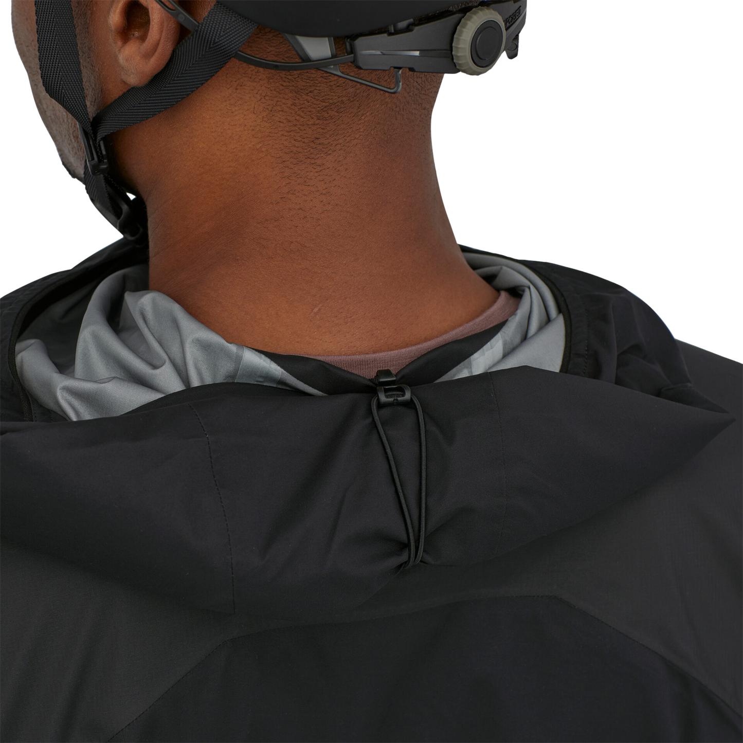Patagonia Dirt Roamer Storm Bike Jacket in Black worn by model, hood detail for rolling up
