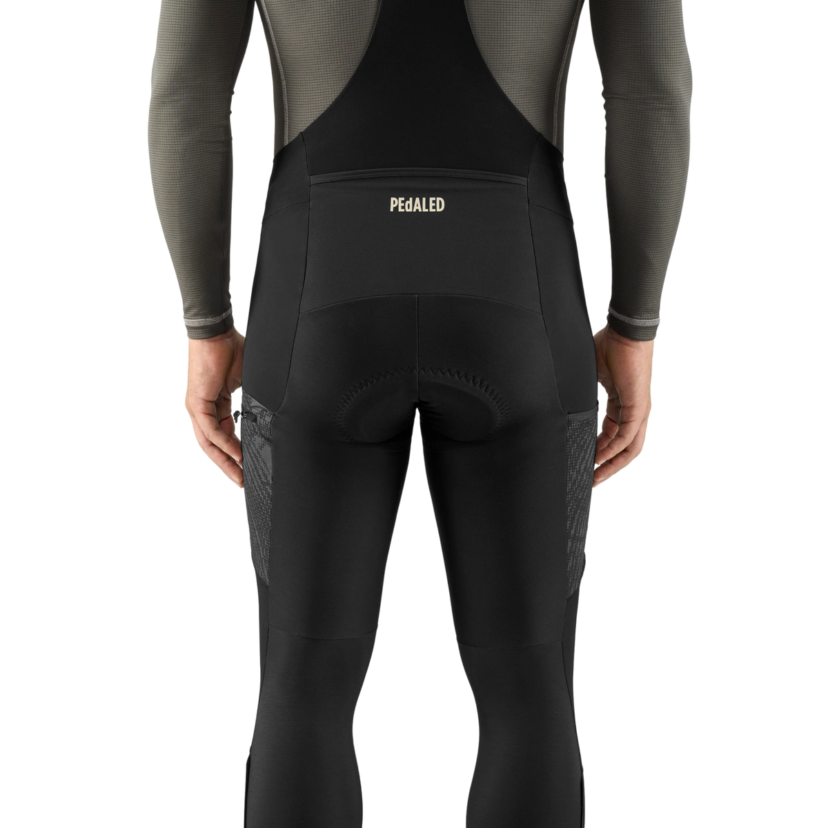 PEdALED Odyssey men's winter cycling bib tights featuring insulating fleece, weather-resistant thigh panels, three cargo pockets and reflective leg details.