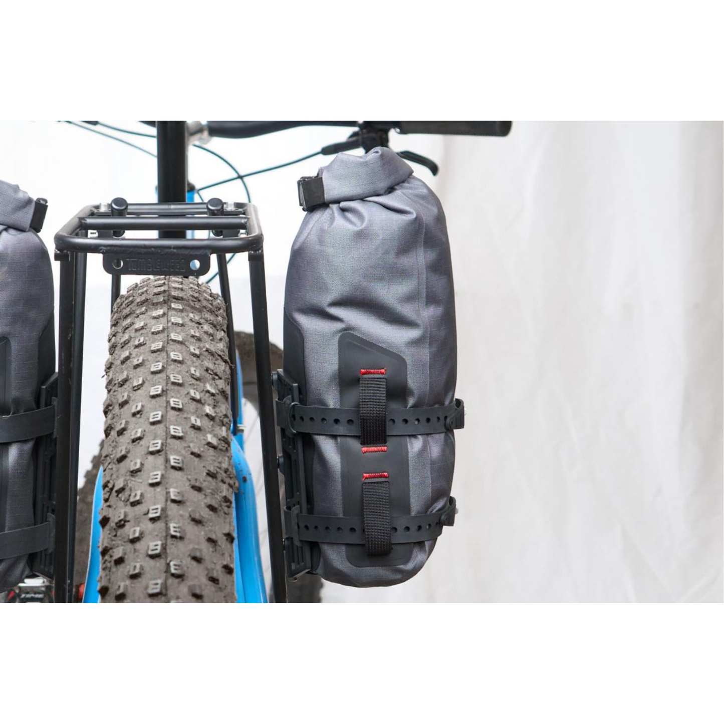 Revelate Designs Tarsier Cage mounted on bike fork carrying dry bag