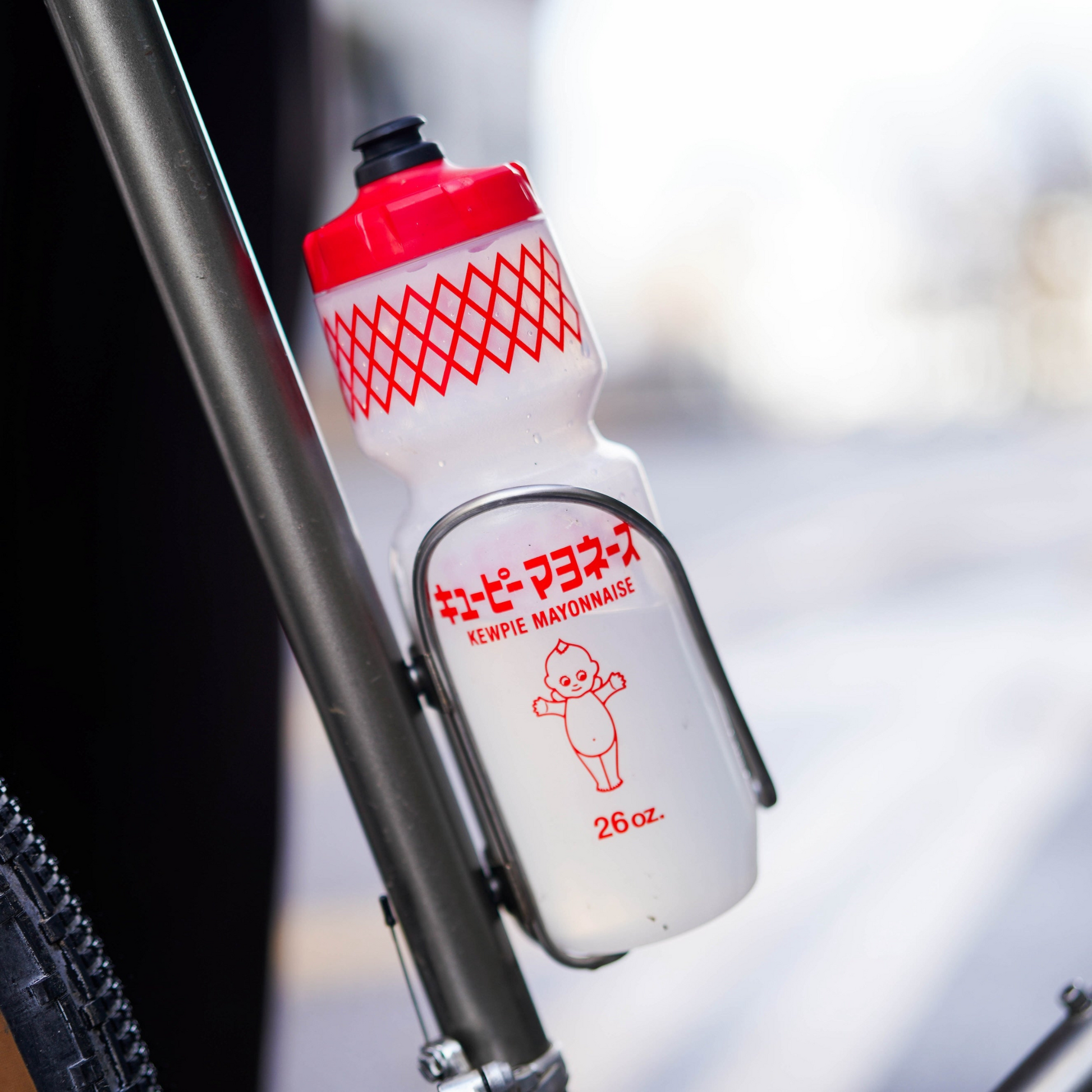 SimWorks Kewpie Mayonnaise Bottle 26oz mounted on a bicycle frame in bottle cage
