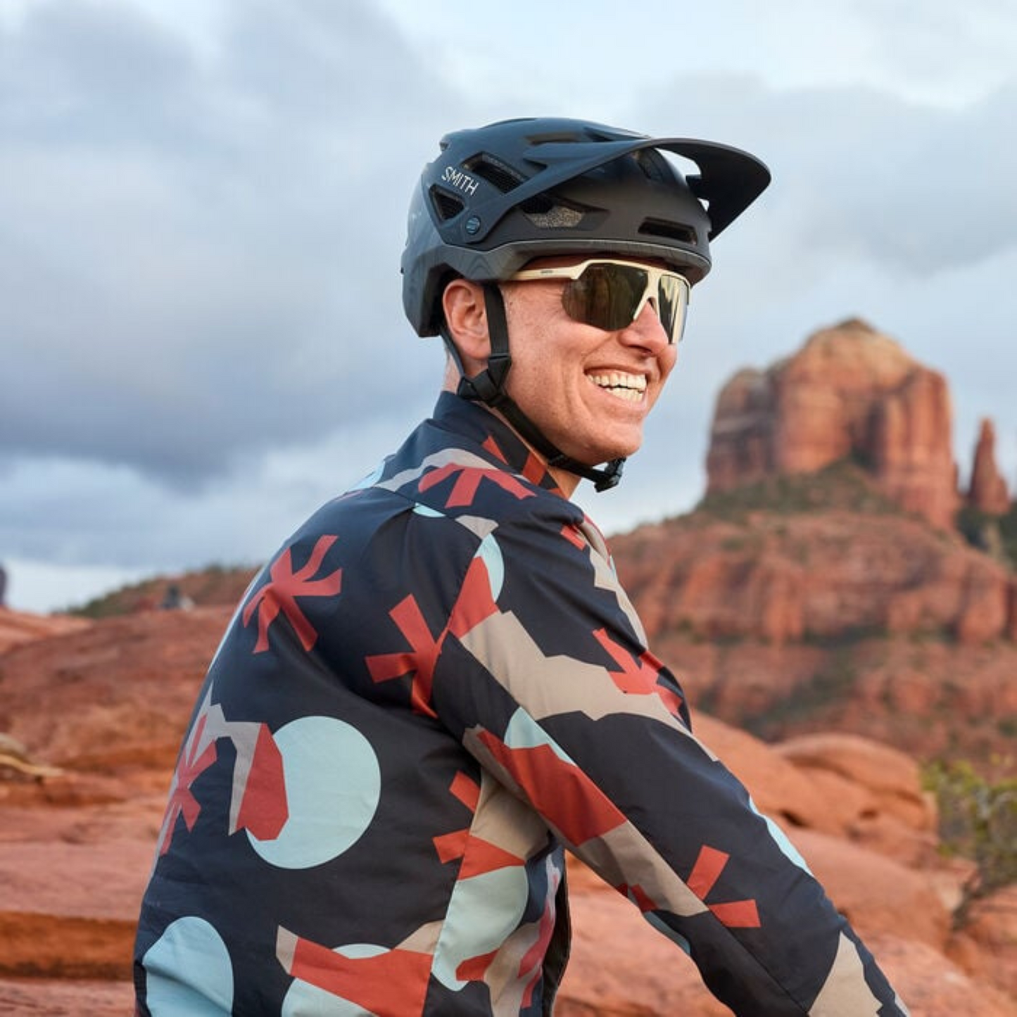 Smith Motive Performance Sunglasses – Matte Bone frame with CP Black Gold Mirror lens worn by cyclist