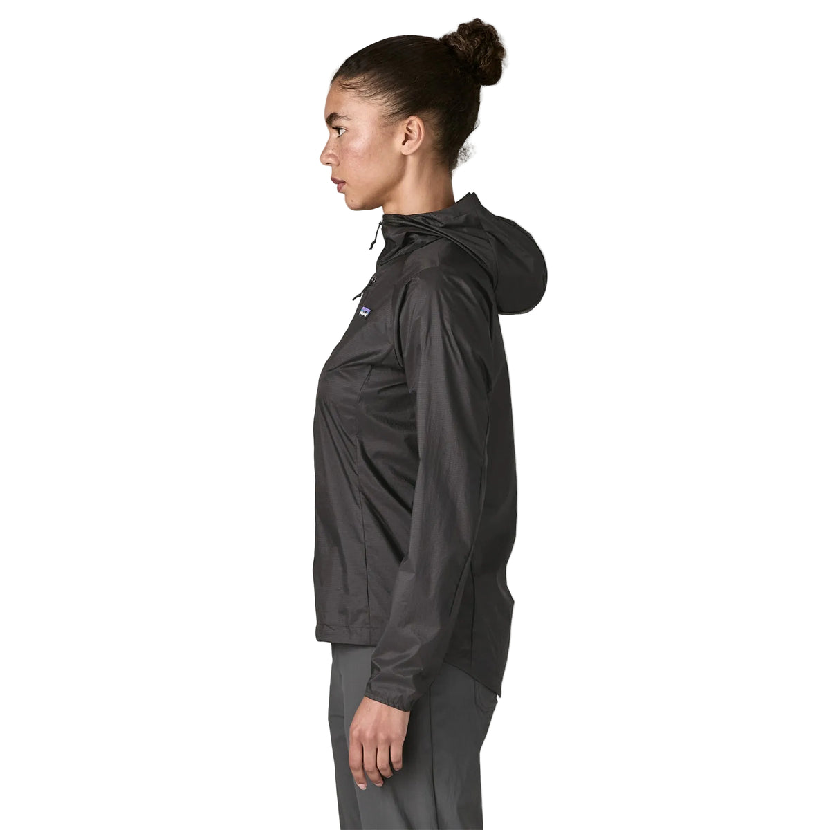 Patagonia Women's Houdini in Black w/Black lightweight windbreaker jacket made from recycled nylon ripstop with adjustable hood, zippered chest pocket and reflective P-6 logo.