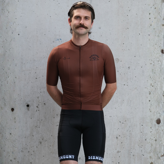 Dismount Bwown! unisex cycling jersey by Givelo with Italian body fabric, raw-edge sleeves, reflective pocket edging and silicone grip waistband.