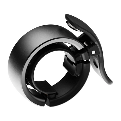 Knog Oi Prima Bike Bell with wrap-around design, WAVETEK hammer technology and hinged clamp for mounting to bicycle handlebars.