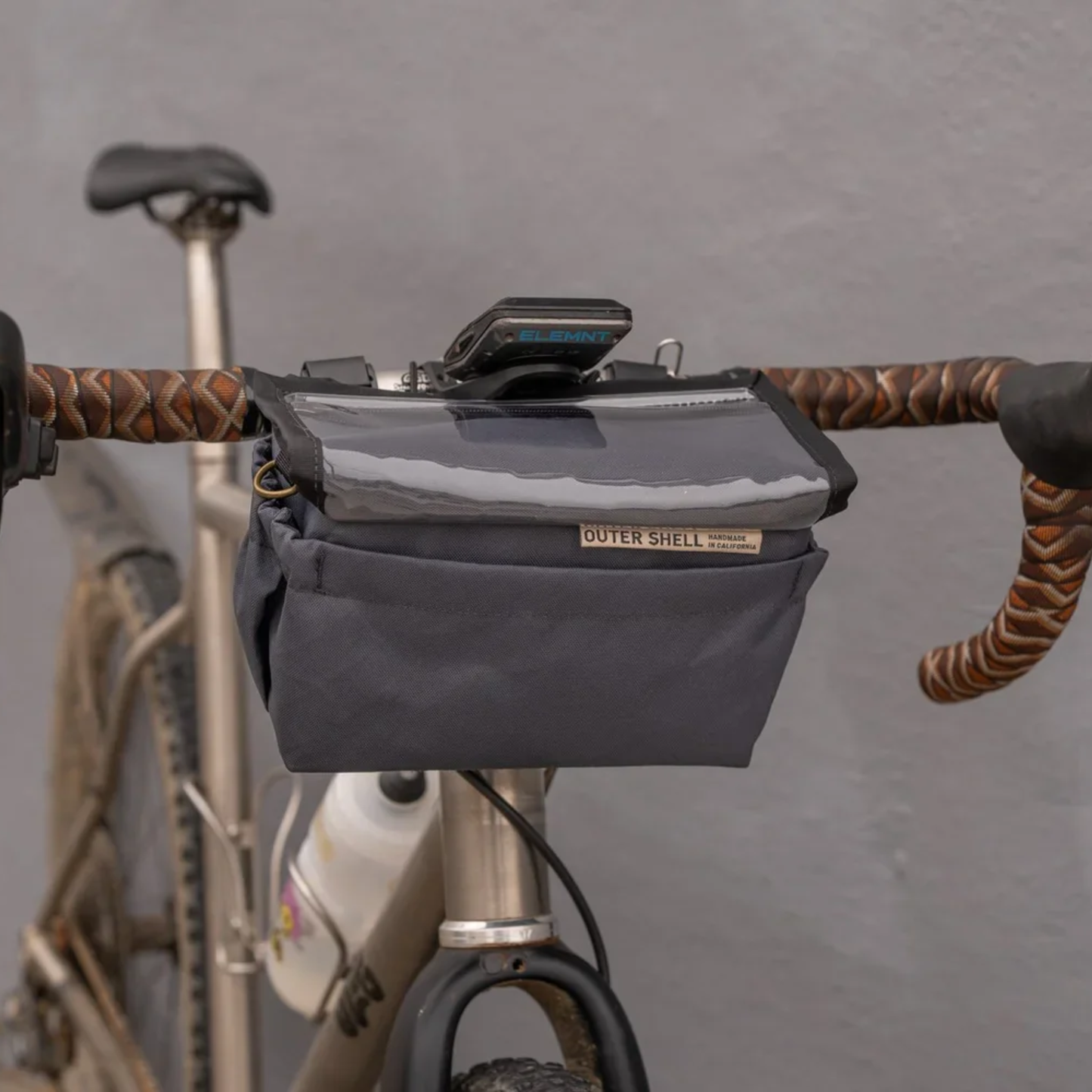 Outer Shell Drawcord Bicycle Handlebar Bag displayed on bike. Designed for storing essentials on bike and one handed access.