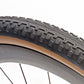 Rene Herse Poteau Mountain 700 x 48 semi-slick gravel tire with a smooth centre tread transitioning into side knobs for traction and cornering grip.