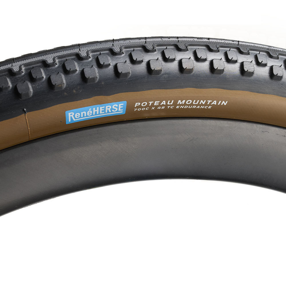 Rene Herse Poteau Mountain 700 x 48 semi-slick gravel tire with a smooth centre tread transitioning into side knobs for traction and cornering grip.