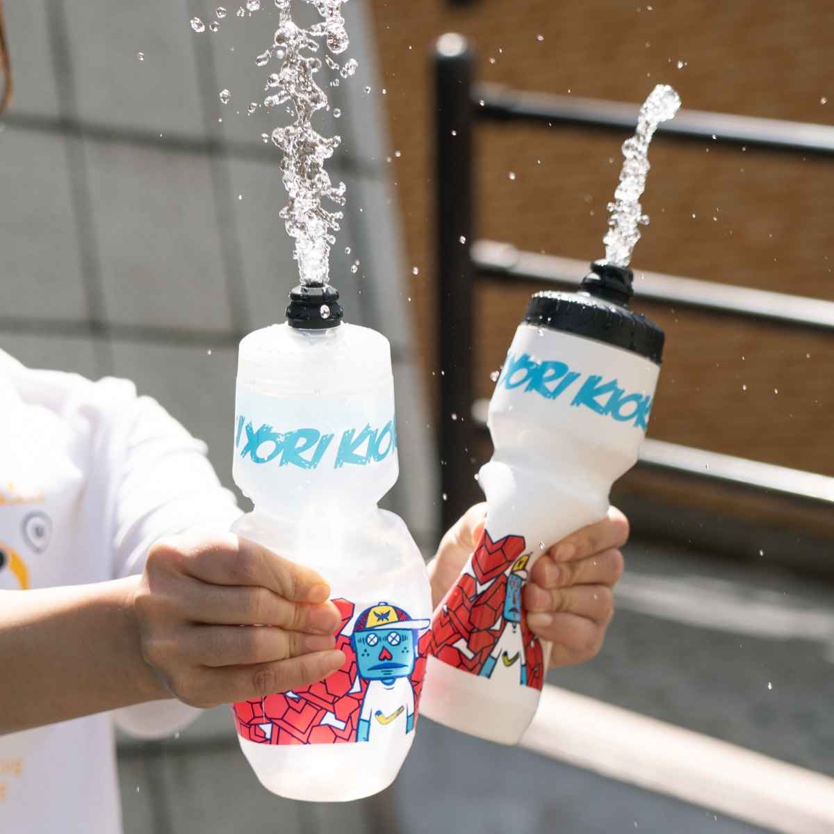 Rokkaku Boy Water Bottle in both Clear and White with blue text and graphic design.