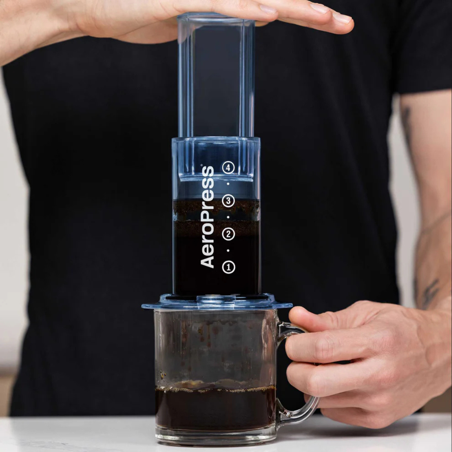 AeroPress Clear Coffee Maker in action being pressed