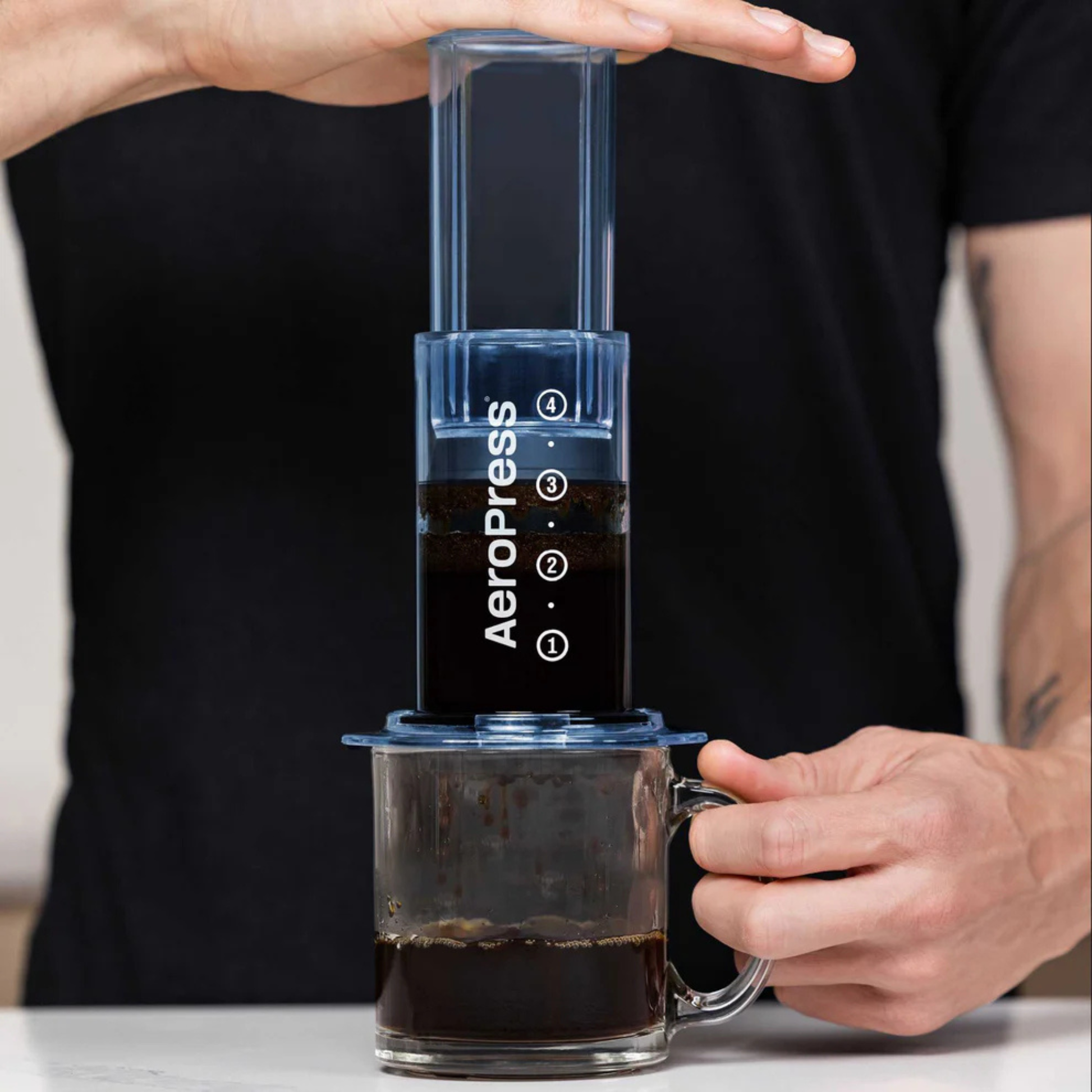 AeroPress Clear Coffee Maker in action being pressed
