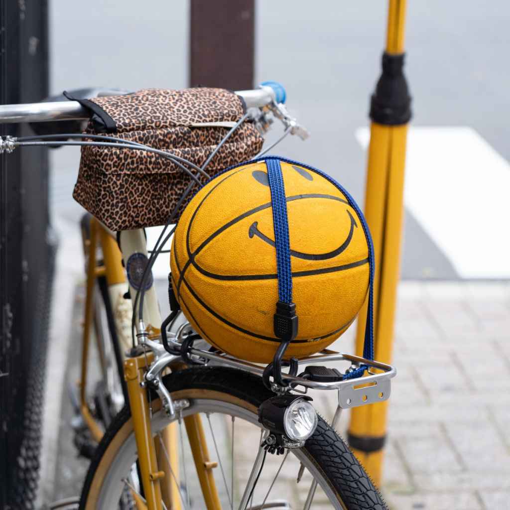 Blue Lug Flat Bungee elastic bicycle cargo strap with steel-structured hooks for securing bags and belongings to bicycle racks and baskets.