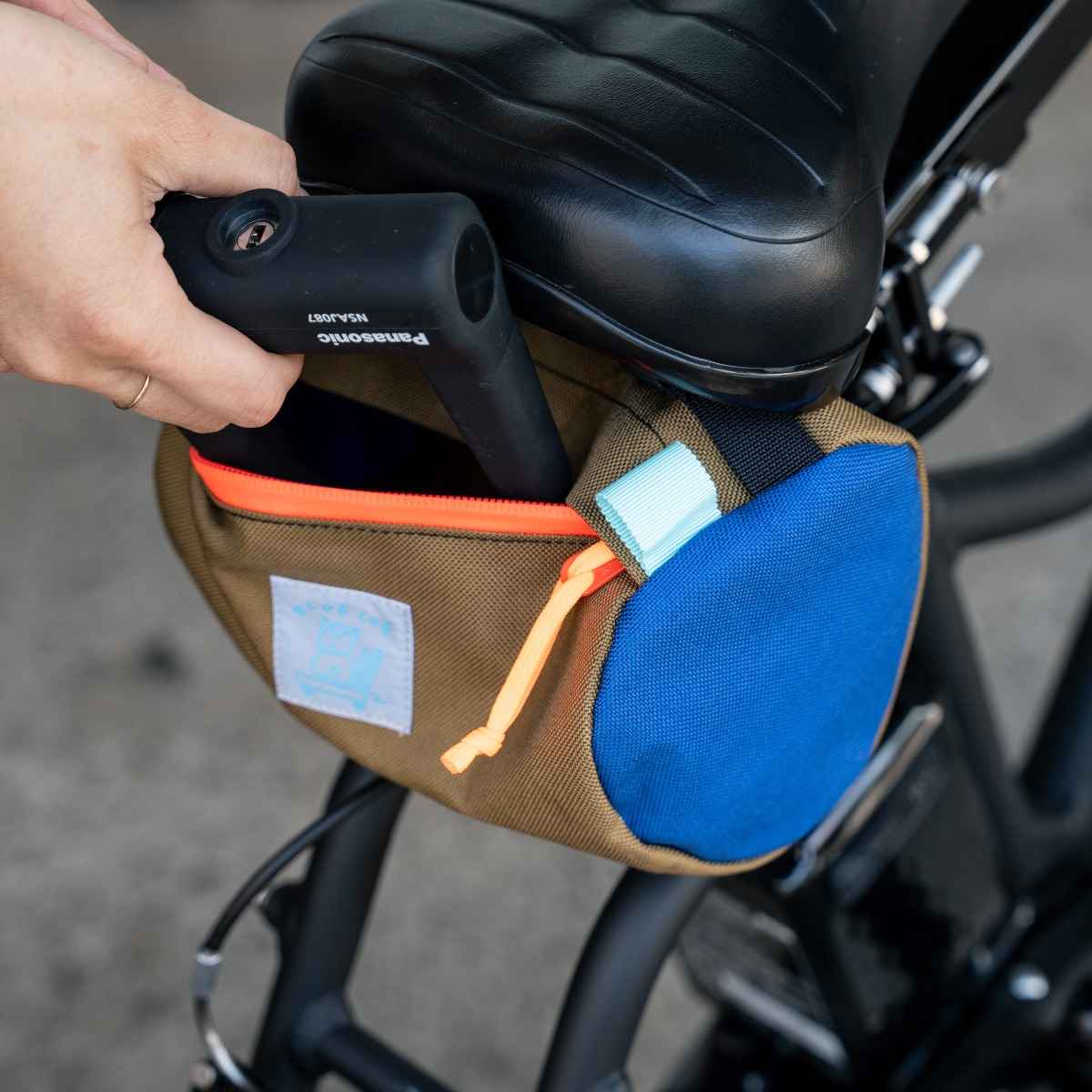 Blue Lug Handlebar Pouch featuring a compact, soft-sided nylon construction with removable straps for mounting to bicycle handlebars.