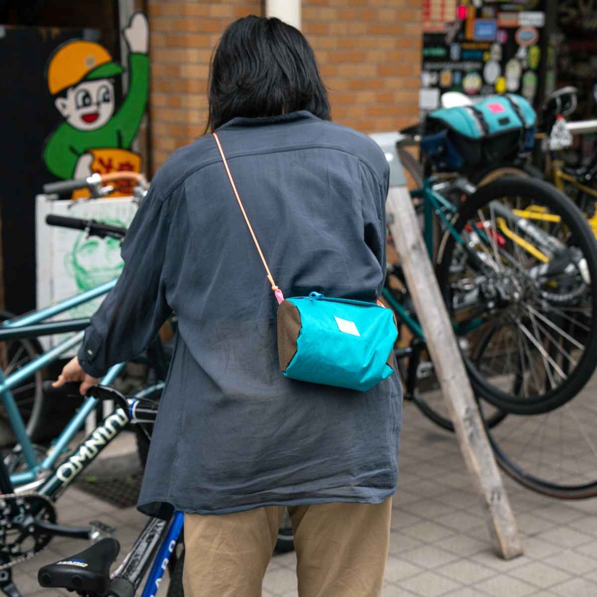Blue Lug Handlebar Pouch featuring a compact, soft-sided nylon construction with removable straps for mounting to bicycle handlebars.