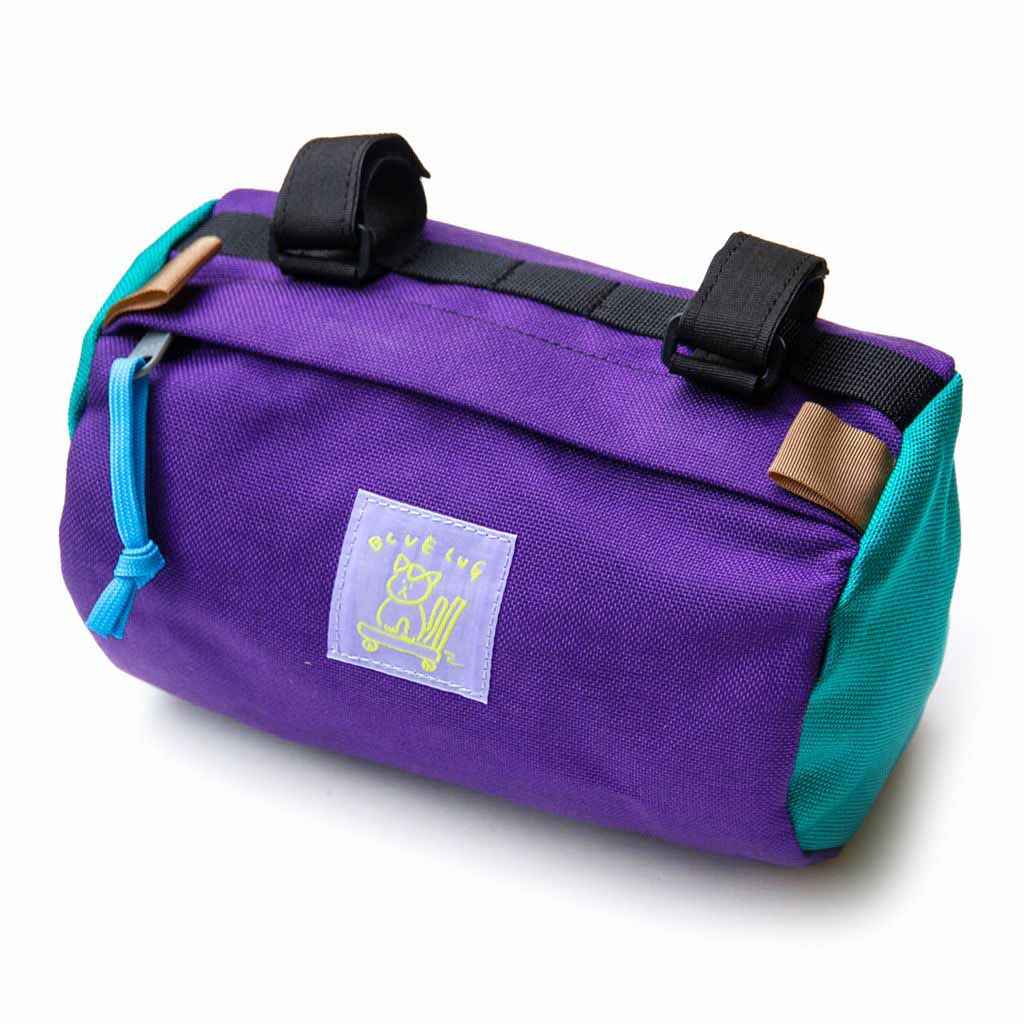 Blue Lug Handlebar Pouch featuring a compact, soft-sided nylon construction with removable straps for mounting to bicycle handlebars.