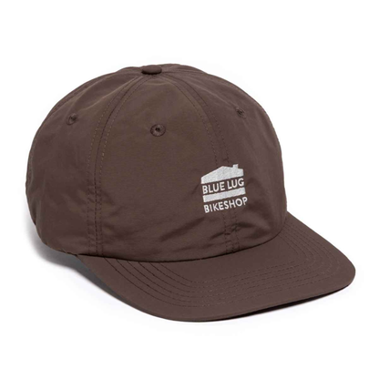 Blue Lug House Logo Cap lightweight nylon six-panel cycling cap in brown on white background