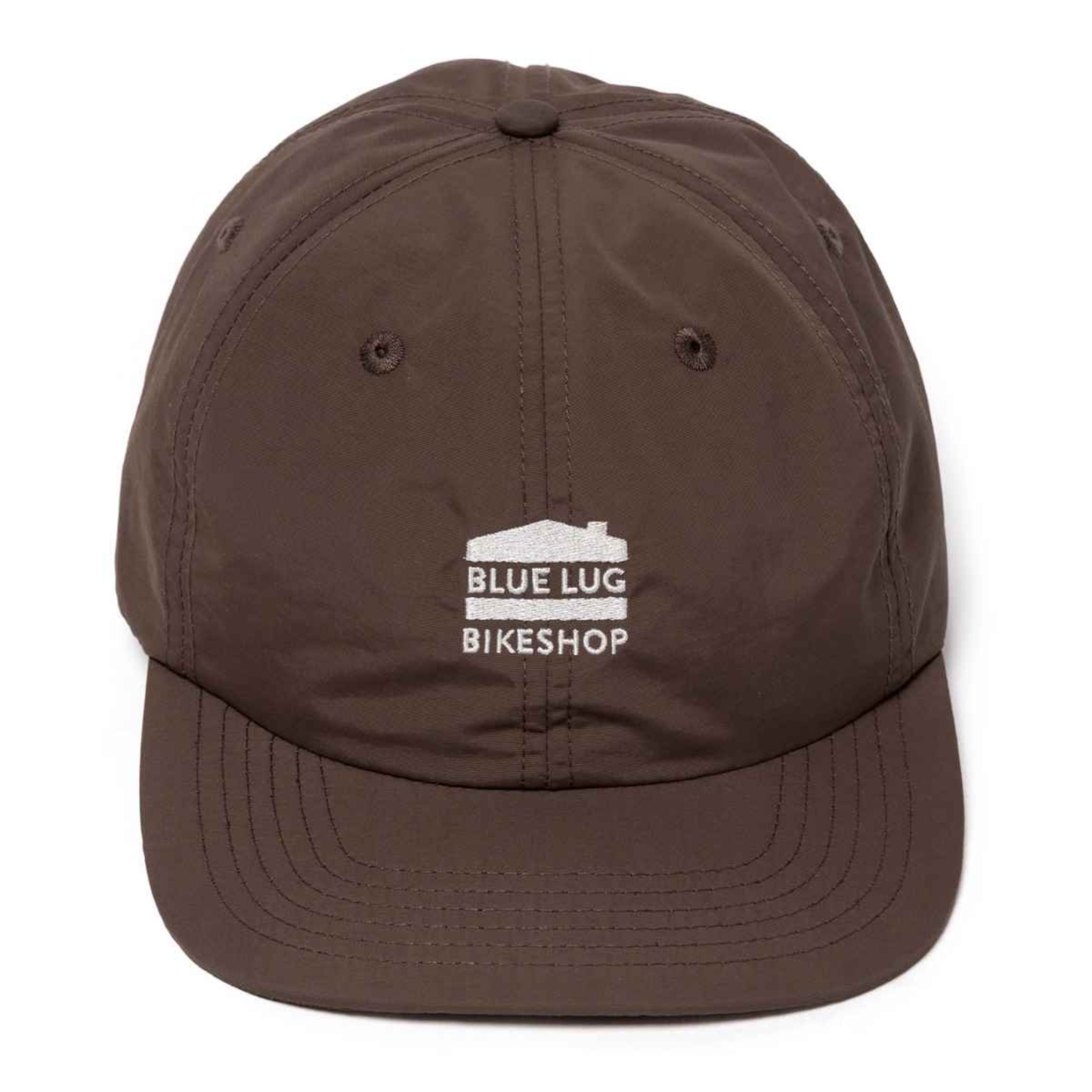 A dark brown 5-panel baseball cap with a white embroidered logo on the front that reads 'BLUE LUG BIKESHOP' with a small house graphic, shown against a plain white background.