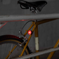 Blue Lug Koma Light Rear compact USB rechargeable bicycle taillight in black mounted to a  mustard colour bike