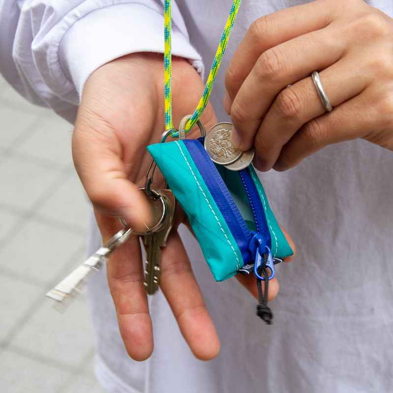Blue Lug Kozeni Pouch, a compact Japanese-made coin and accessory pouch available in assorted technical fabrics and printed designs.