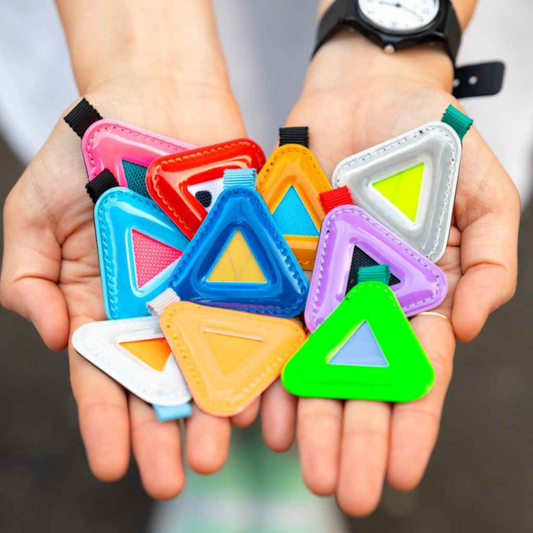 Blue Lug Mini Triangle Reflectors in assorted colours being held in hands