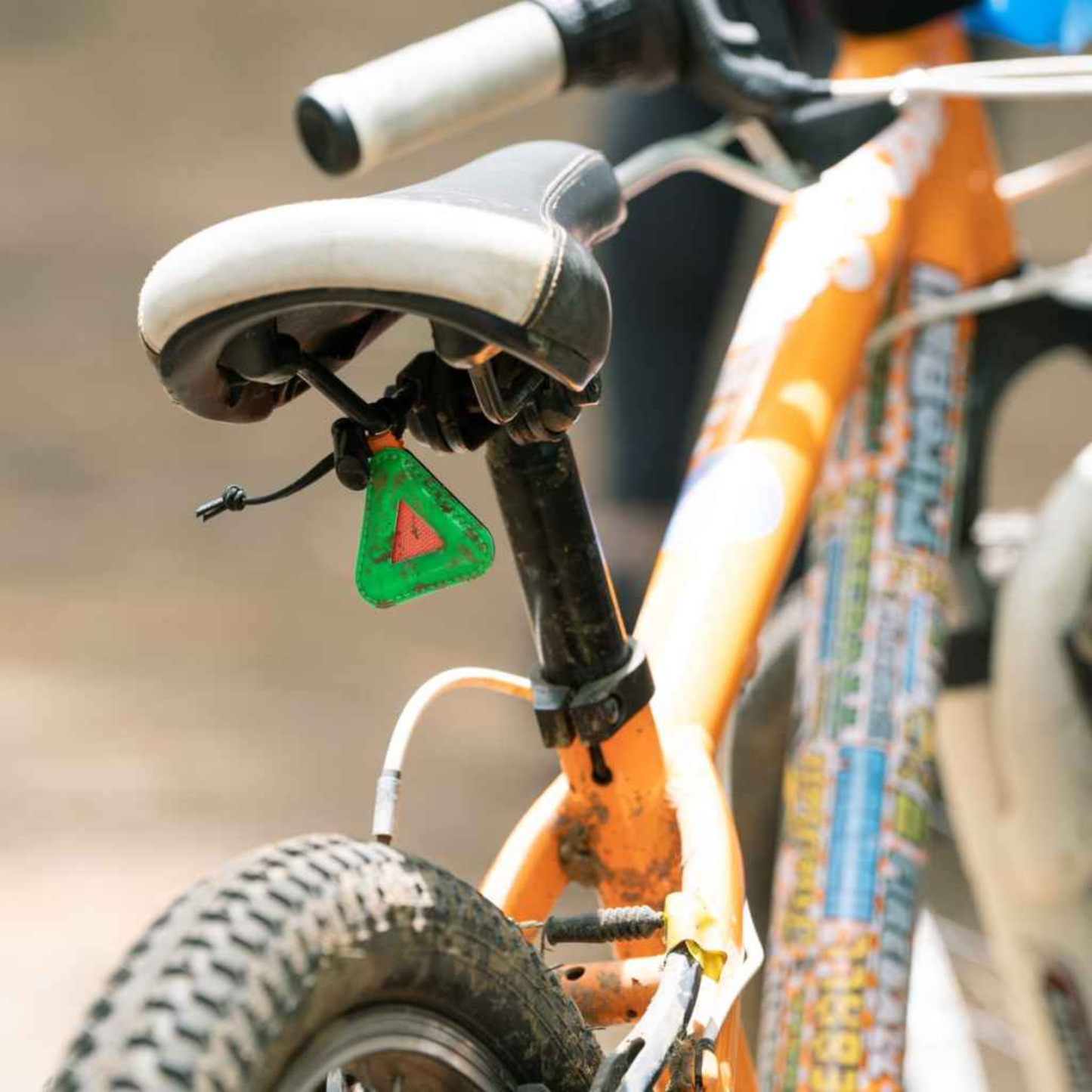 Blue Lug Mini Triangle Reflector in assorted colours mounted on a bicycle saddle
