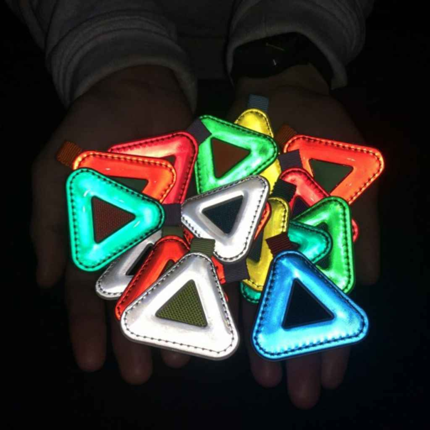 Blue Lug Mini Triangle Reflector in assorted colours shown with flash photo to show how reflective they are