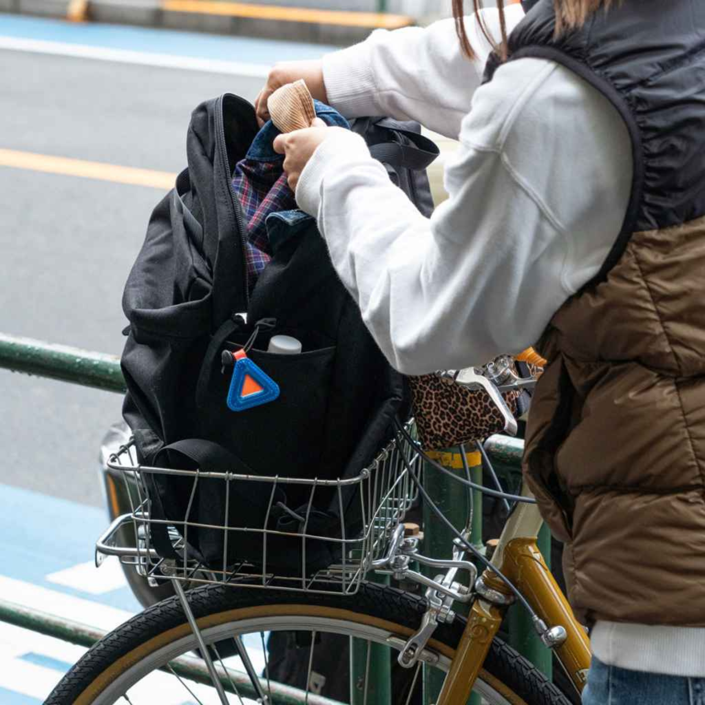 Blue Lug Mini Triangle Reflector in assorted colours mounted on a bicycle bag in basket