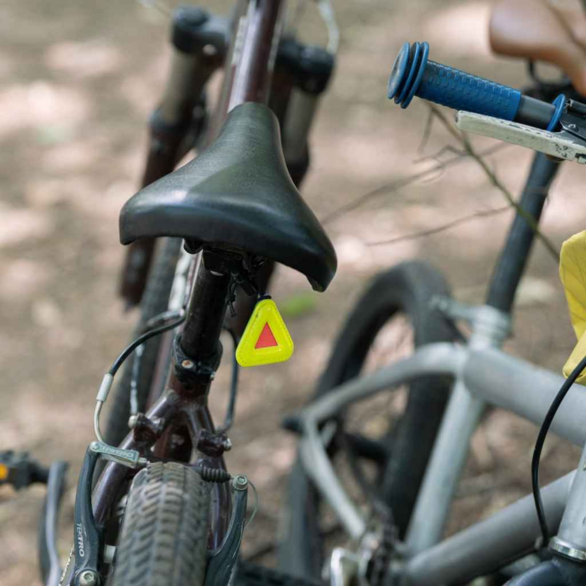 Blue Lug Mini Triangle Reflector in assorted colours mounted on a black bicycle saddle 
