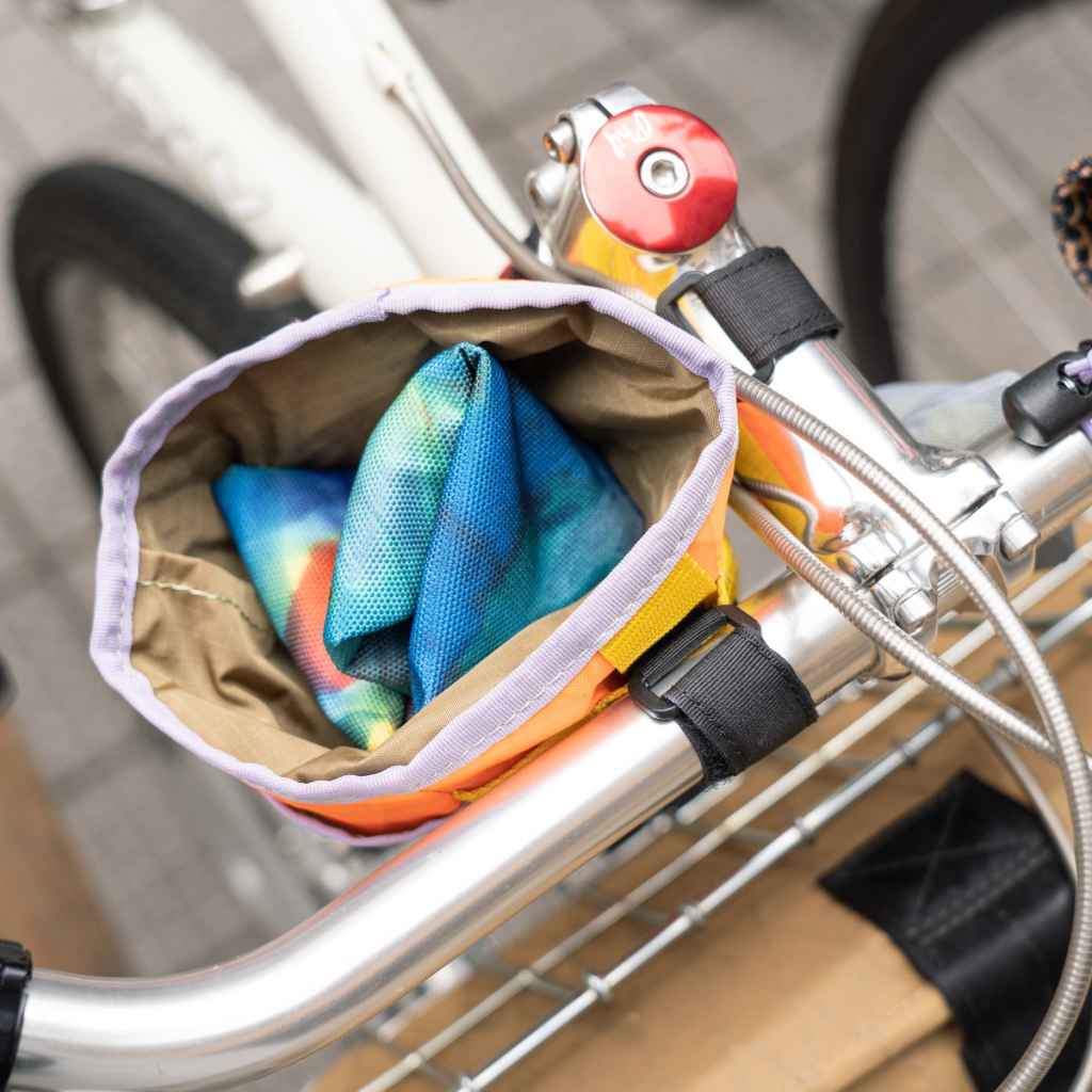 Blue Lug Saddle Cover in Tiedye designed for protecting bicycle saddles from the elements. Waterproof, packable and easy to stow.