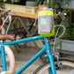 Blue Lug Stem Pouch mounted on handlebar. Designed for carrying essentials by bike. Available Canada wide.