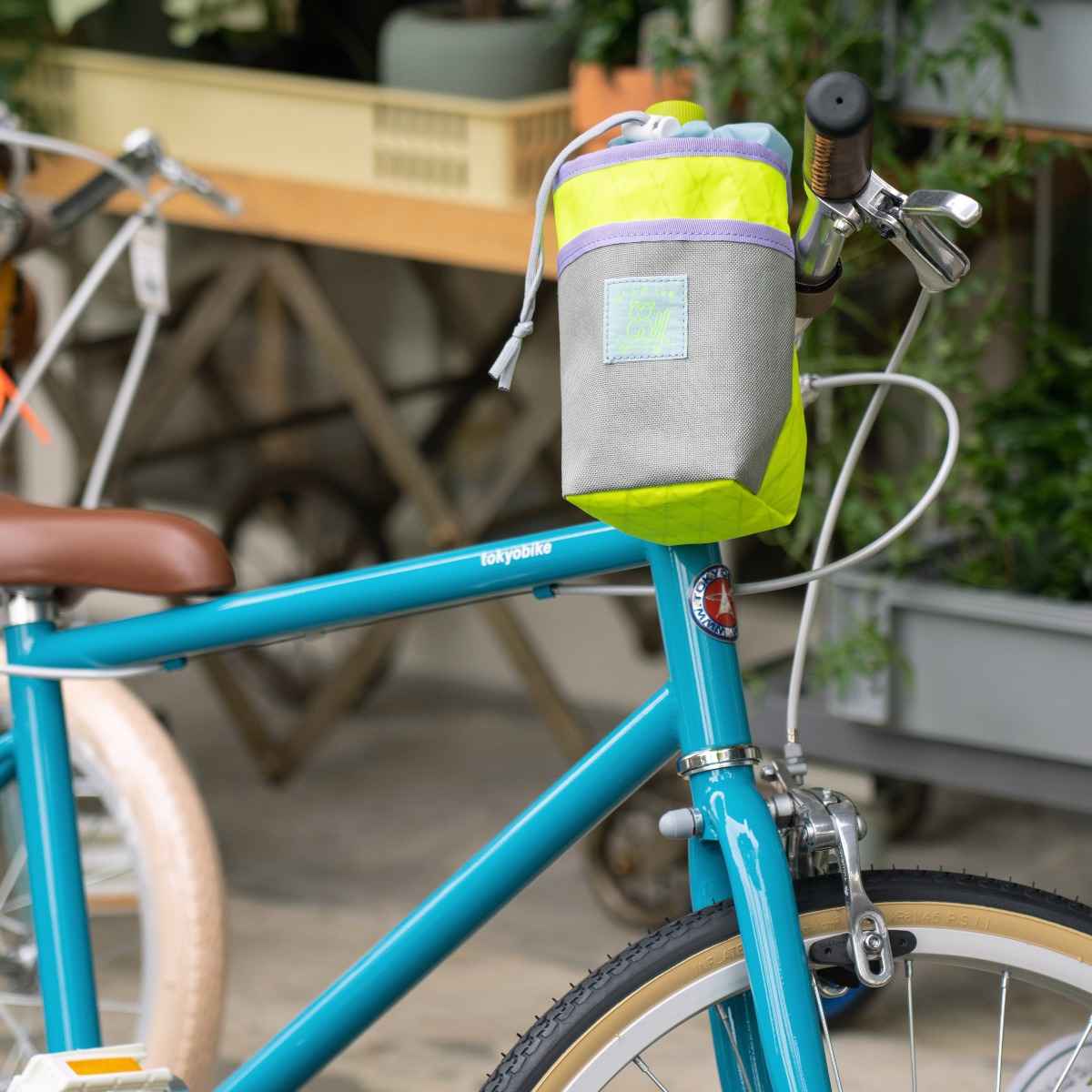 Blue Lug Stem Pouch mounted on handlebar. Designed for carrying essentials by bike. Available Canada wide.