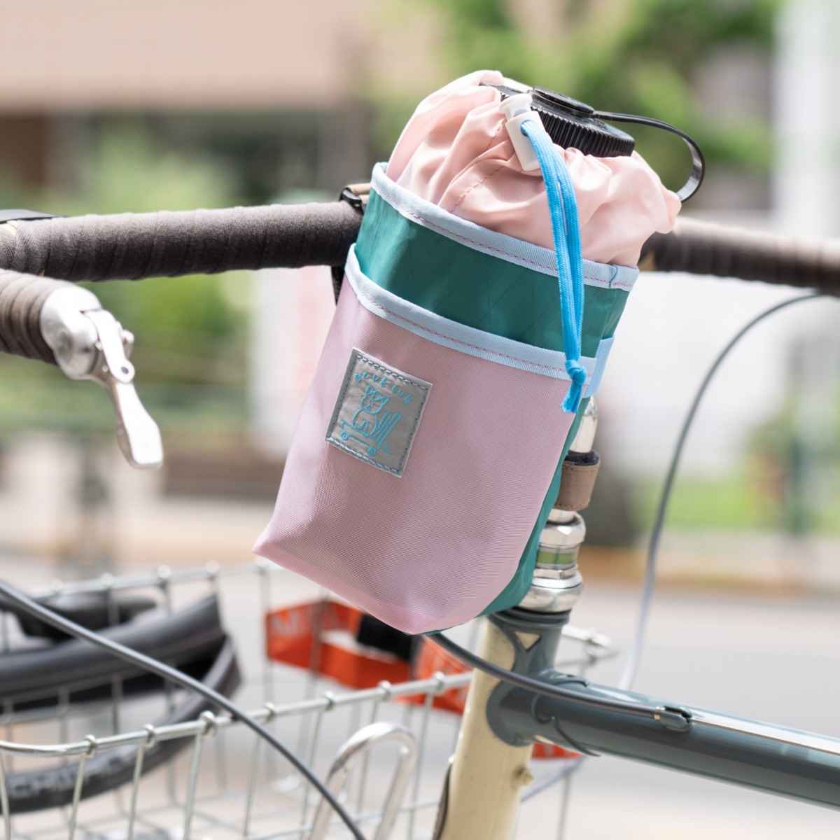 Blue Lug Stem Pouch mounted on handlebar. Designed for carrying essentials by bike. Available Canada wide.