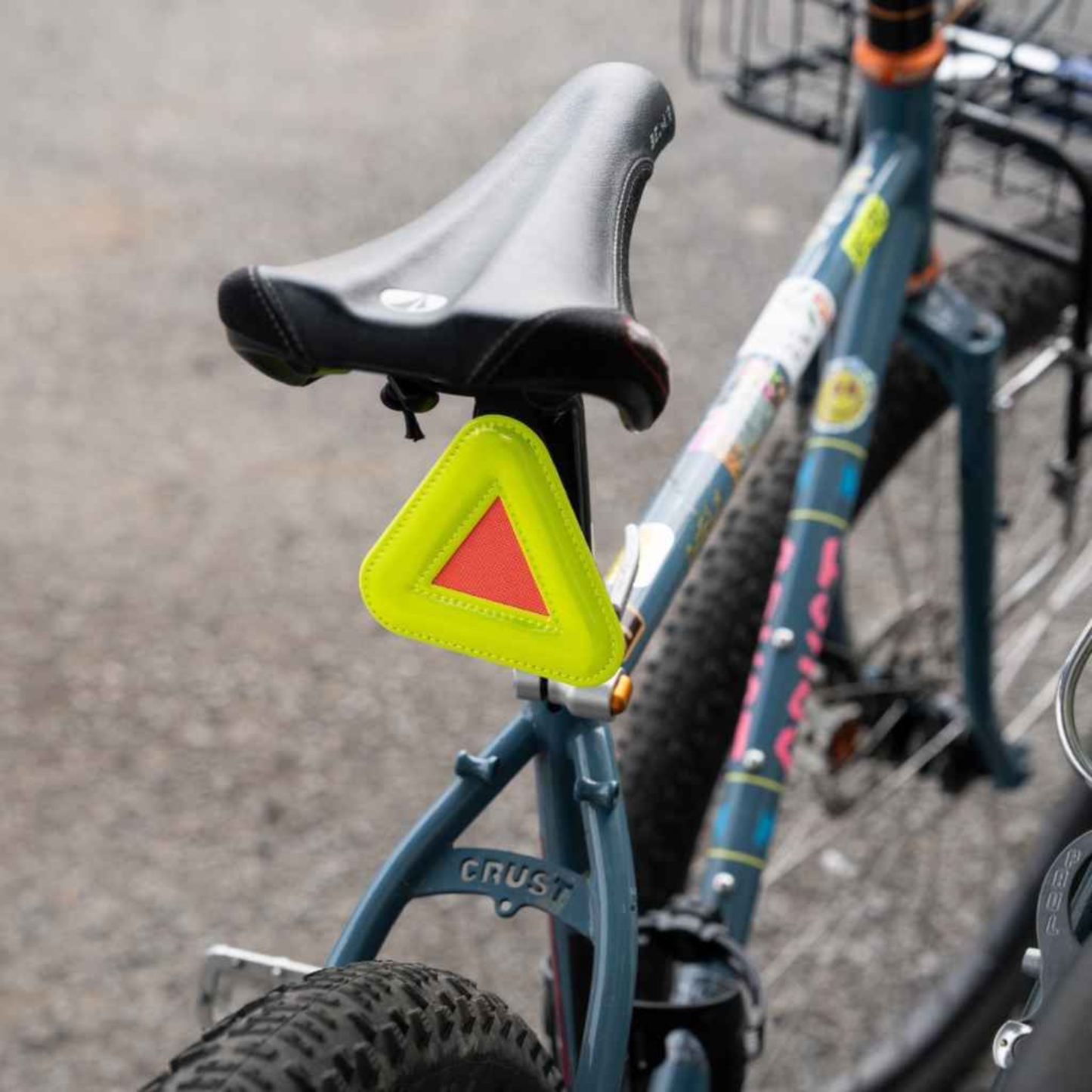 Blue Lug Triangle Reflector in Yellow mounted beneath a bicycle saddle