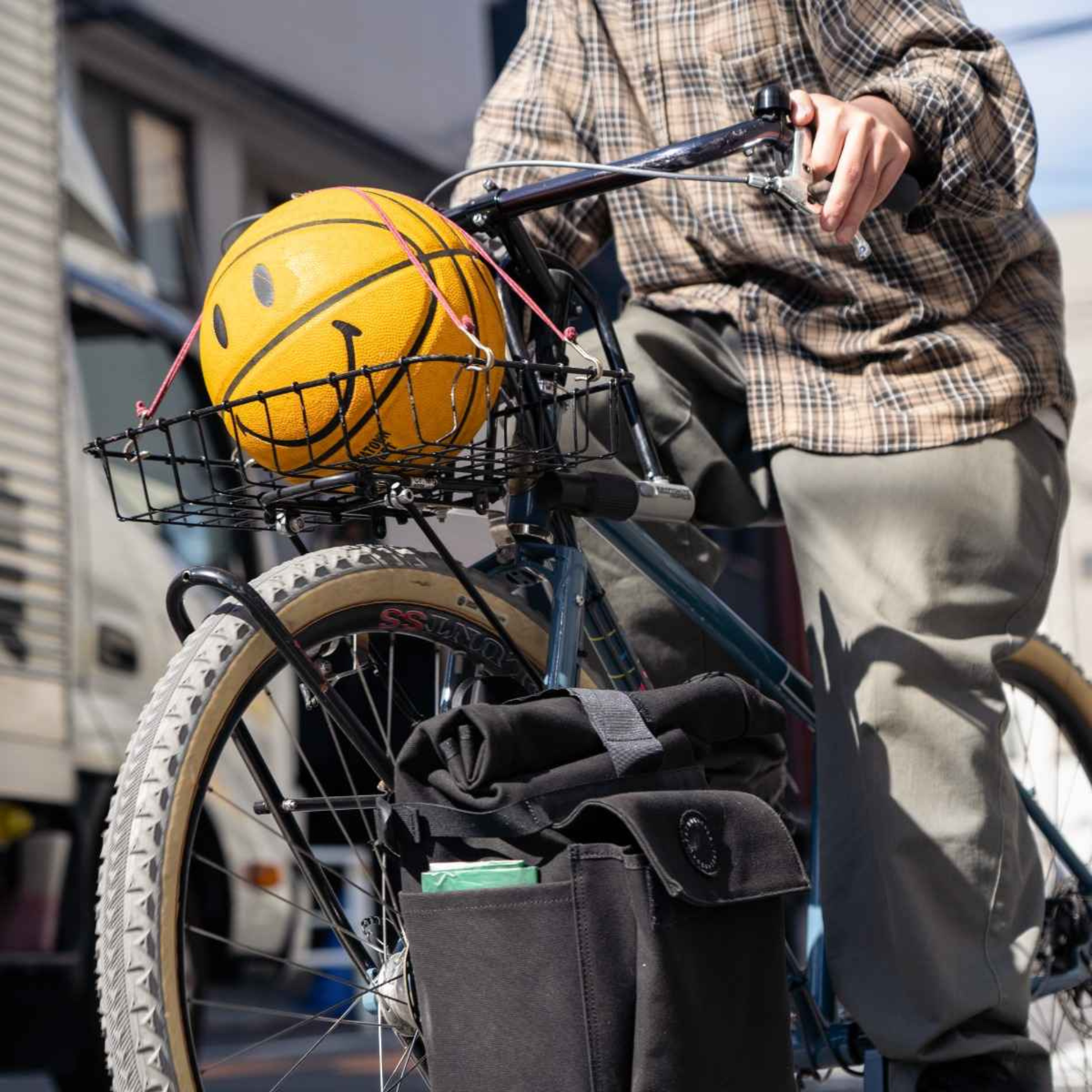 Blue Lug X-Strap elastic cargo strap in holding a ball in a basket on bicycle