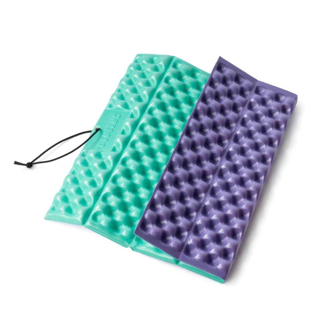 Blue Lug Puff Seat folding foam seat pad in green and purple. Foldable camping seat for on the go and bike rides. Fits Wald basket.