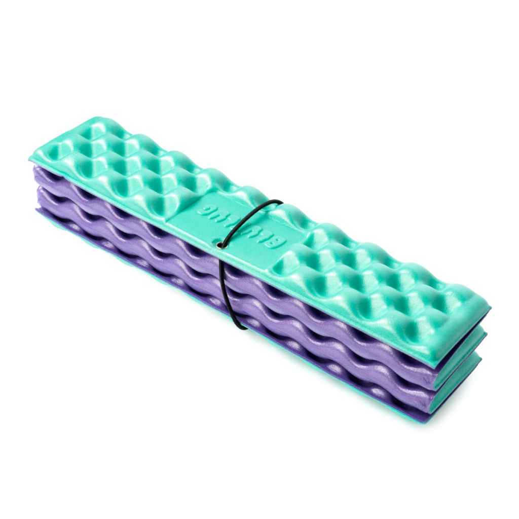 Blue Lug Puff Seat folding foam seat pad in green and purple. Foldable camping seat for on the go and bike rides. Fits Wald basket.