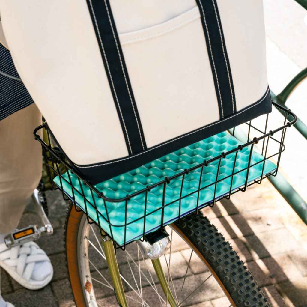 Blue Lug Puff Seat folding foam seat pad in green and purple. Foldable camping seat for on the go and bike rides. Fits Wald basket.