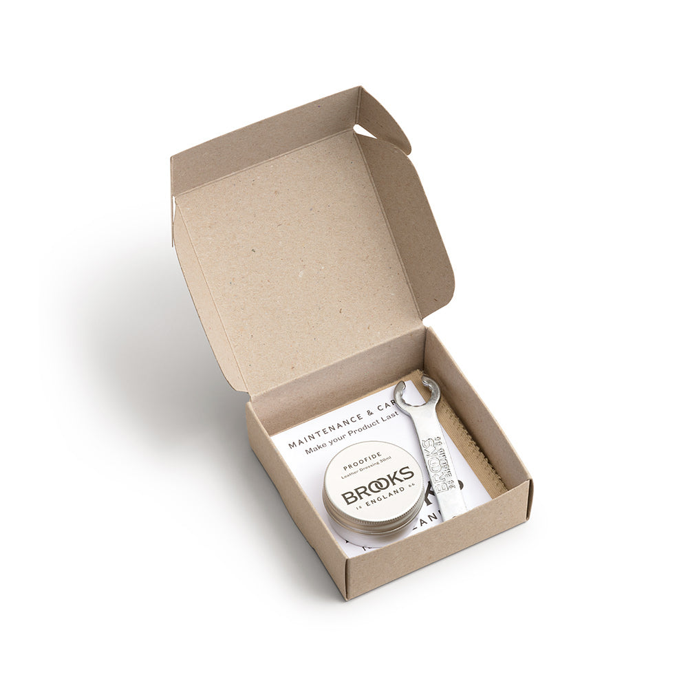 Brooks England Leather Saddle Care Kit containing a 30ml tin of Proofide leather dressing, cotton polishing cloth and Brooks saddle tensioning spanner.