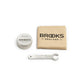 Brooks England Leather Saddle Care Kit containing a 30ml tin of Proofide leather dressing, cotton polishing cloth and Brooks saddle tensioning spanner.