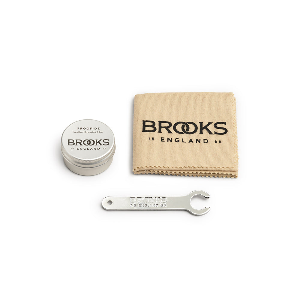 Brooks England Leather Saddle Care Kit containing a 30ml tin of Proofide leather dressing, cotton polishing cloth and Brooks saddle tensioning spanner.