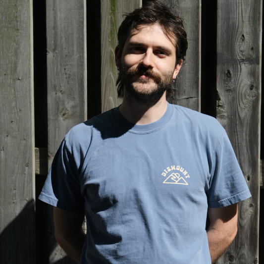 Dismount Mountain T-Shirt printed on the Comfort Colors 1717 Heavyweight Tee in Blue Jean.