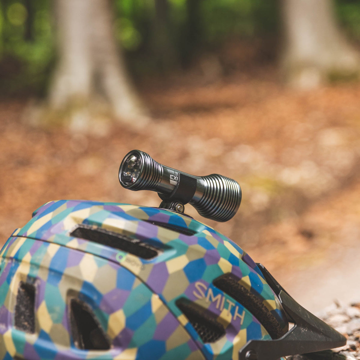 Exposure Lights Diablo 15 rechargeable 2000-lumen bicycle helmet light with gunmetal grey CNC-machined aluminium body and adjustable action camera-compatible helmet mount.