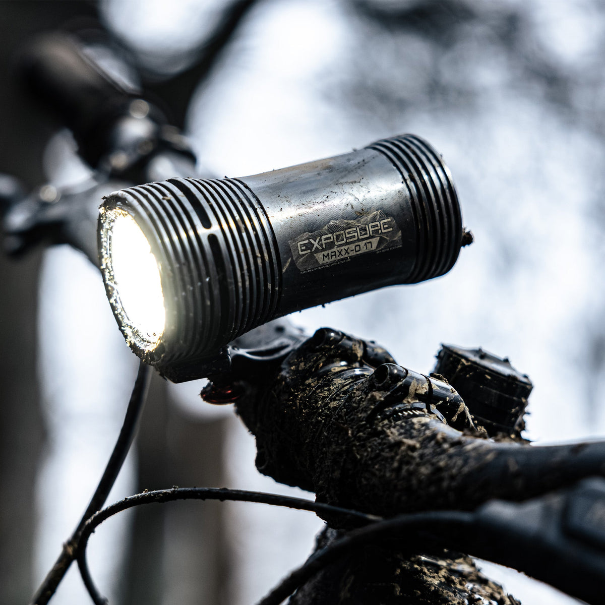 Exposure Lights MaXx-D 17 rechargeable front bicycle light with gunmetal grey CNC-machined aluminium body, 4850-lumen REFLEX output and colour OLED display.