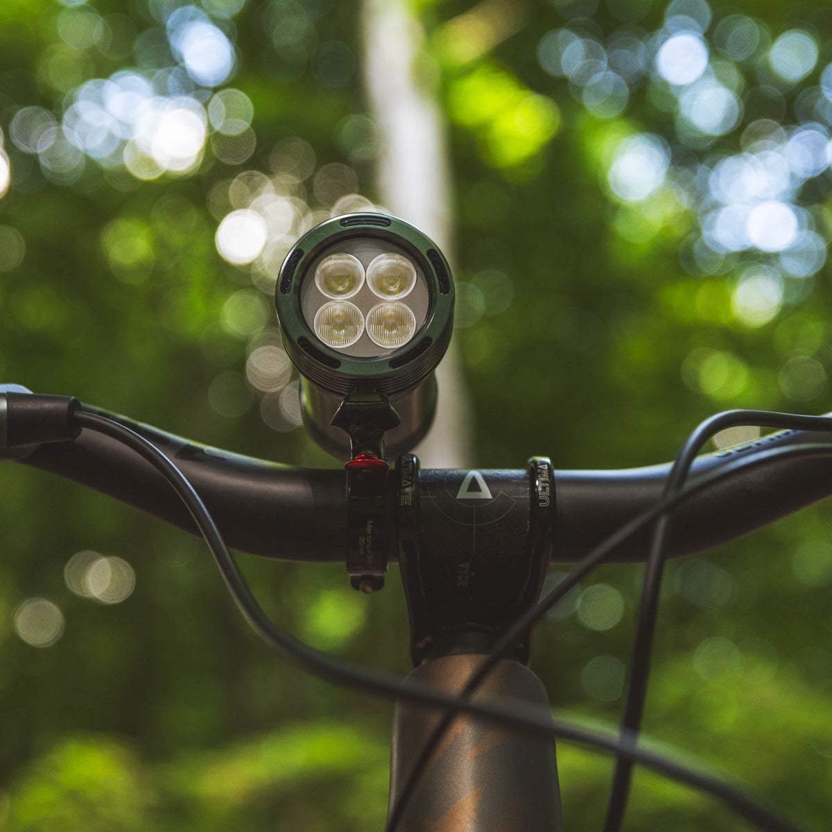 Exposure Lights MaXx-D 17 rechargeable front bicycle light with gunmetal grey CNC-machined aluminium body, 4850-lumen REFLEX output and colour OLED display.