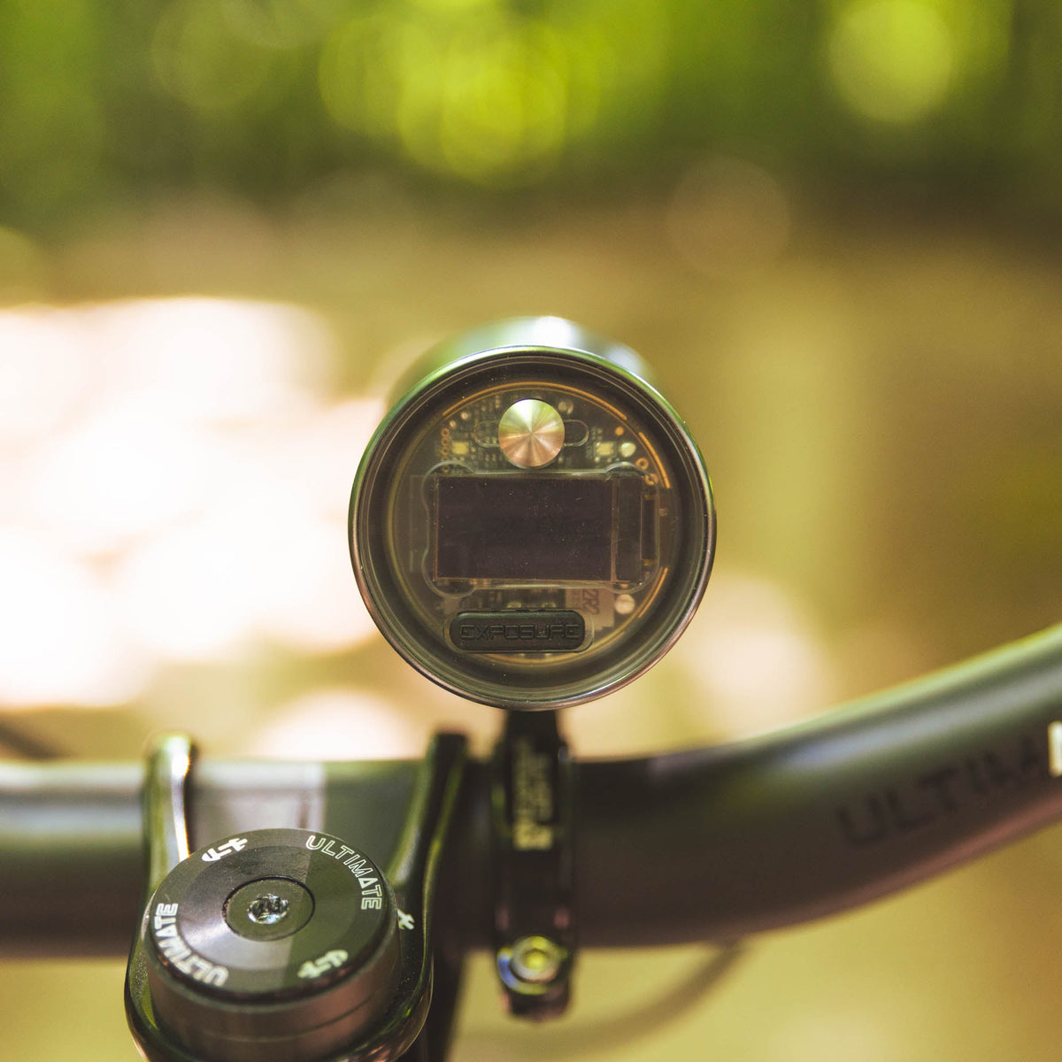 Exposure Lights MaXx-D 17 rechargeable front bicycle light with gunmetal grey CNC-machined aluminium body, 4850-lumen REFLEX output and colour OLED display.