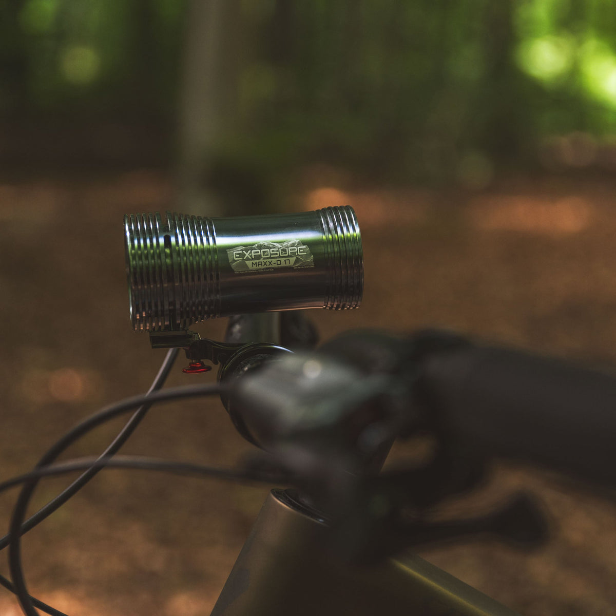 Exposure Lights MaXx-D 17 rechargeable front bicycle light with gunmetal grey CNC-machined aluminium body, 4850-lumen REFLEX output and colour OLED display.