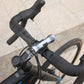 Exposure Lights Sirius 11 rechargeable front bicycle light with gunmetal grey CNC-machined aluminium body, 1300-lumen output and USB-C charging.