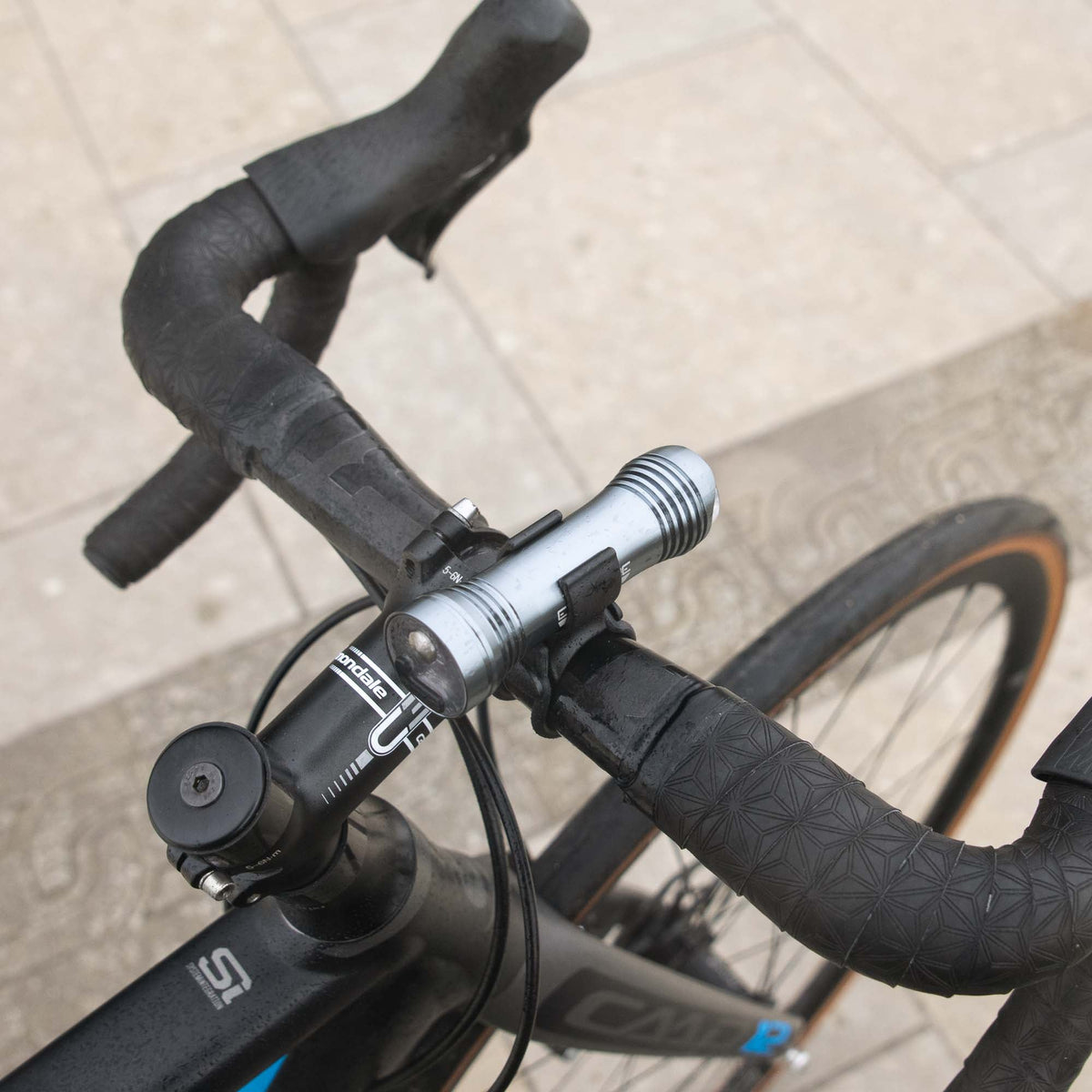 Exposure Lights Sirius 11 rechargeable front bicycle light with gunmetal grey CNC-machined aluminium body, 1300-lumen output and USB-C charging.